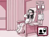 Nia sentada en una silla en el centro de infusión.