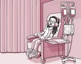Nia sentada en una silla en el centro de infusión.